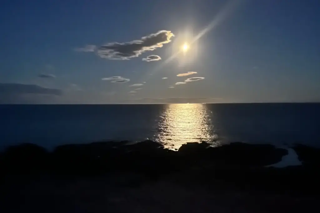 The moon over the sky, sea and shore seen from the settee